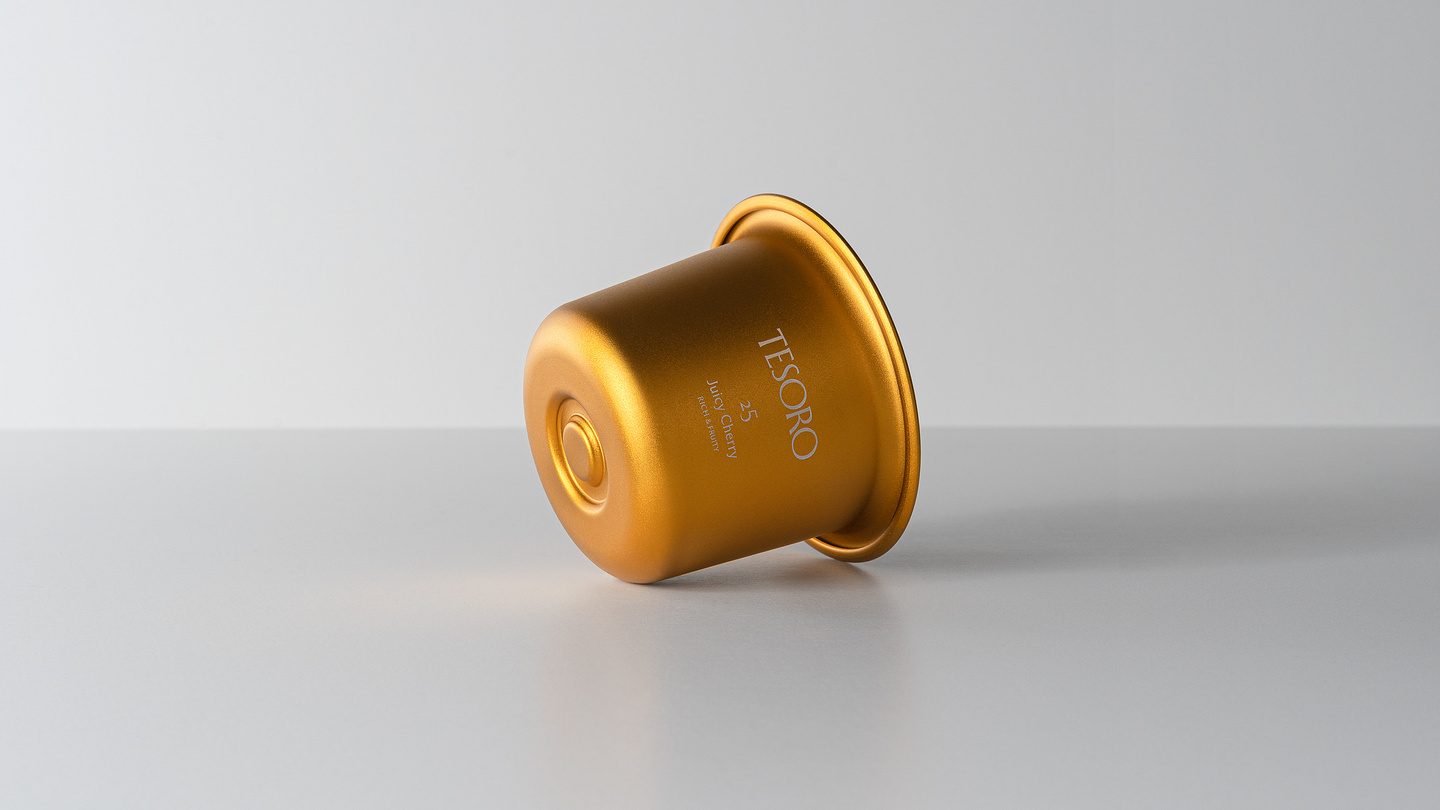 Gold-toned metallic candle refill insert resting on a white background