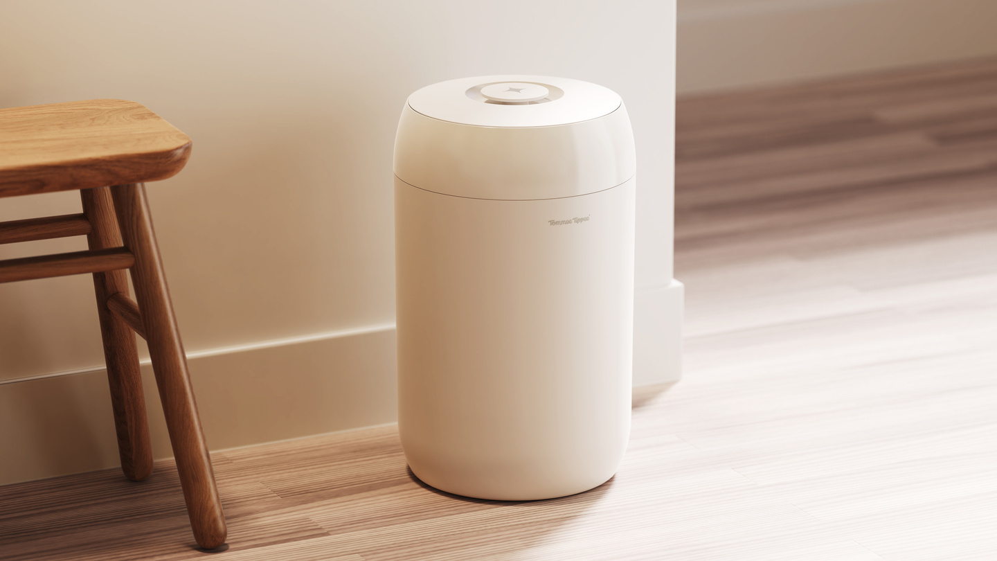 White cylindrical product standing on floor beside a wooden stool