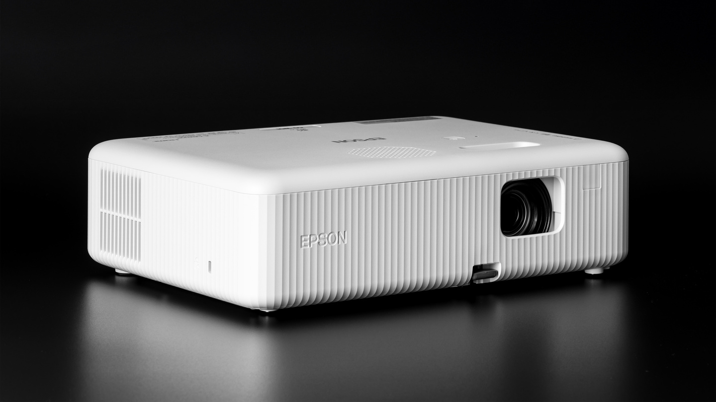 Angled perspective view of a white home projector on dark background