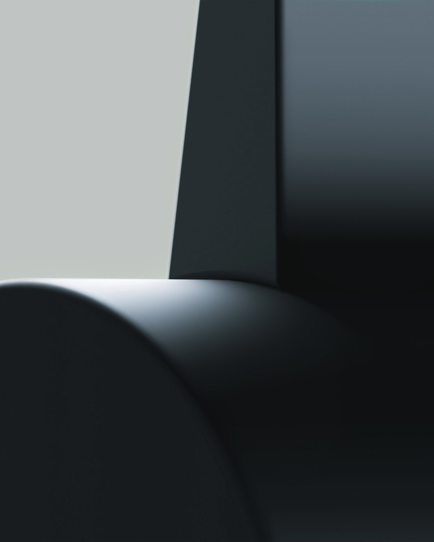 Close-up view of a dark sleek curved eyewear product frame against a grey gradient