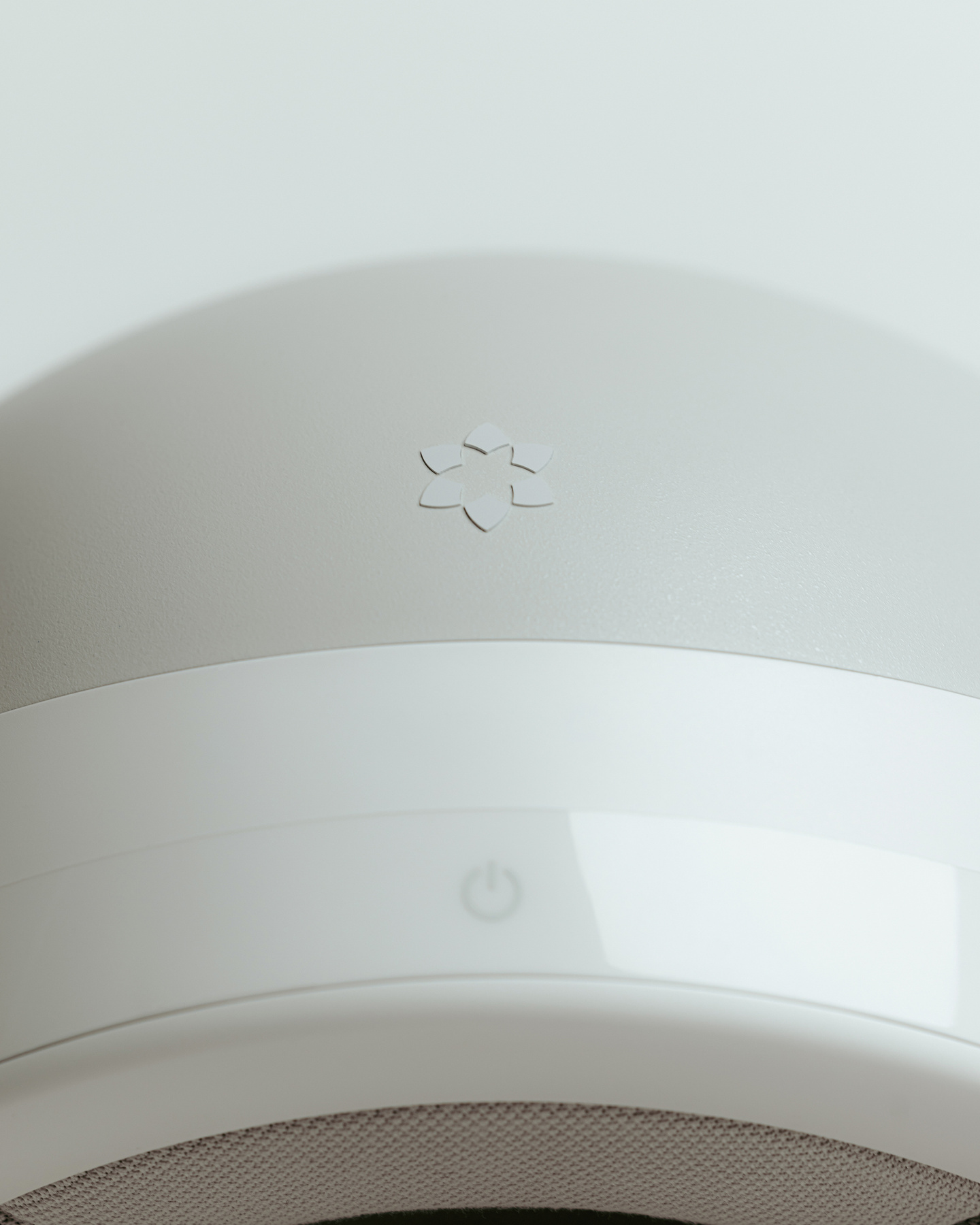 Close-up photograph of smooth white curved plastic enclosure