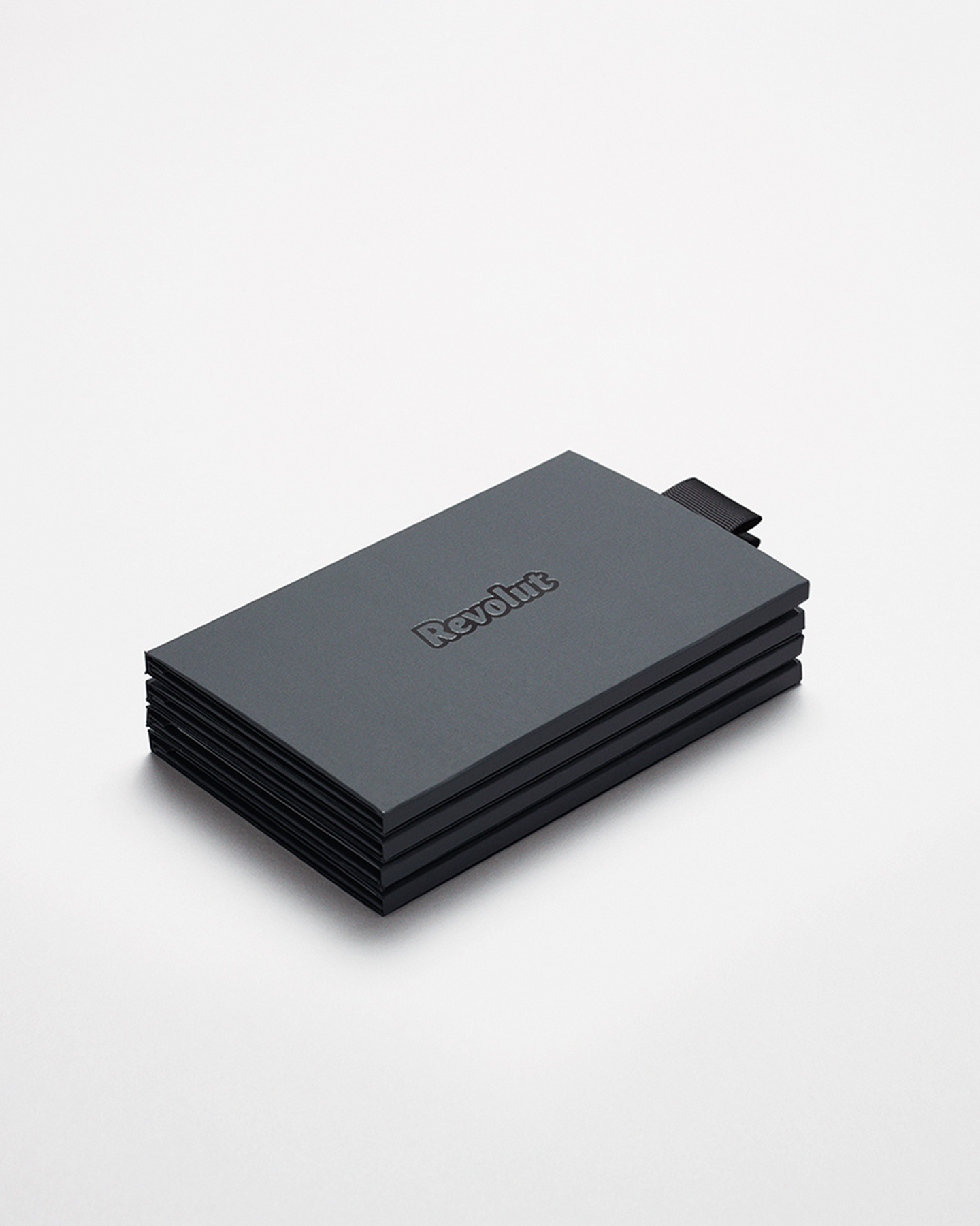 Black Revolut branded card packaging box on a light surface.