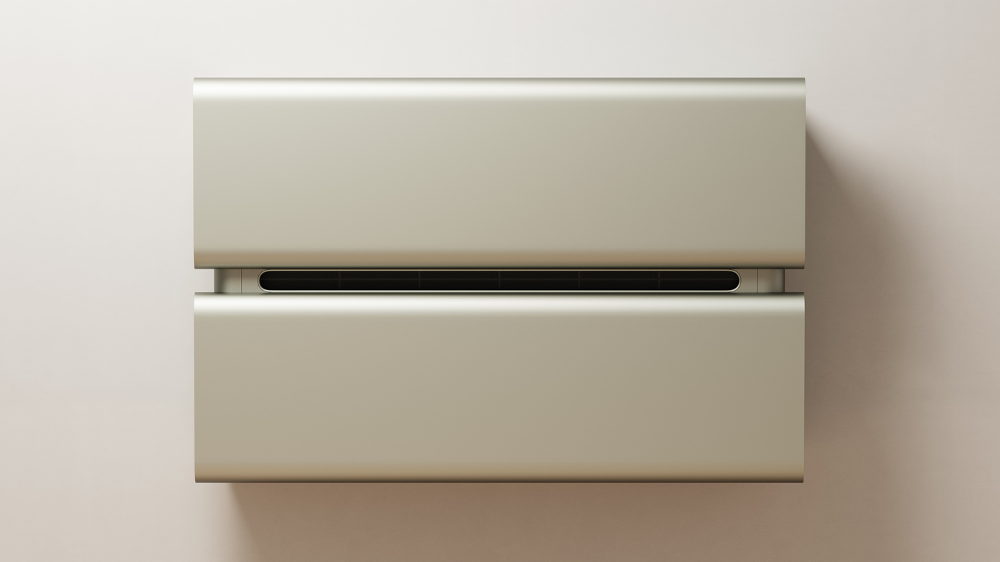 Front view of a minimalist champagne-coloured air conditioner unit mounted on a beige wall.