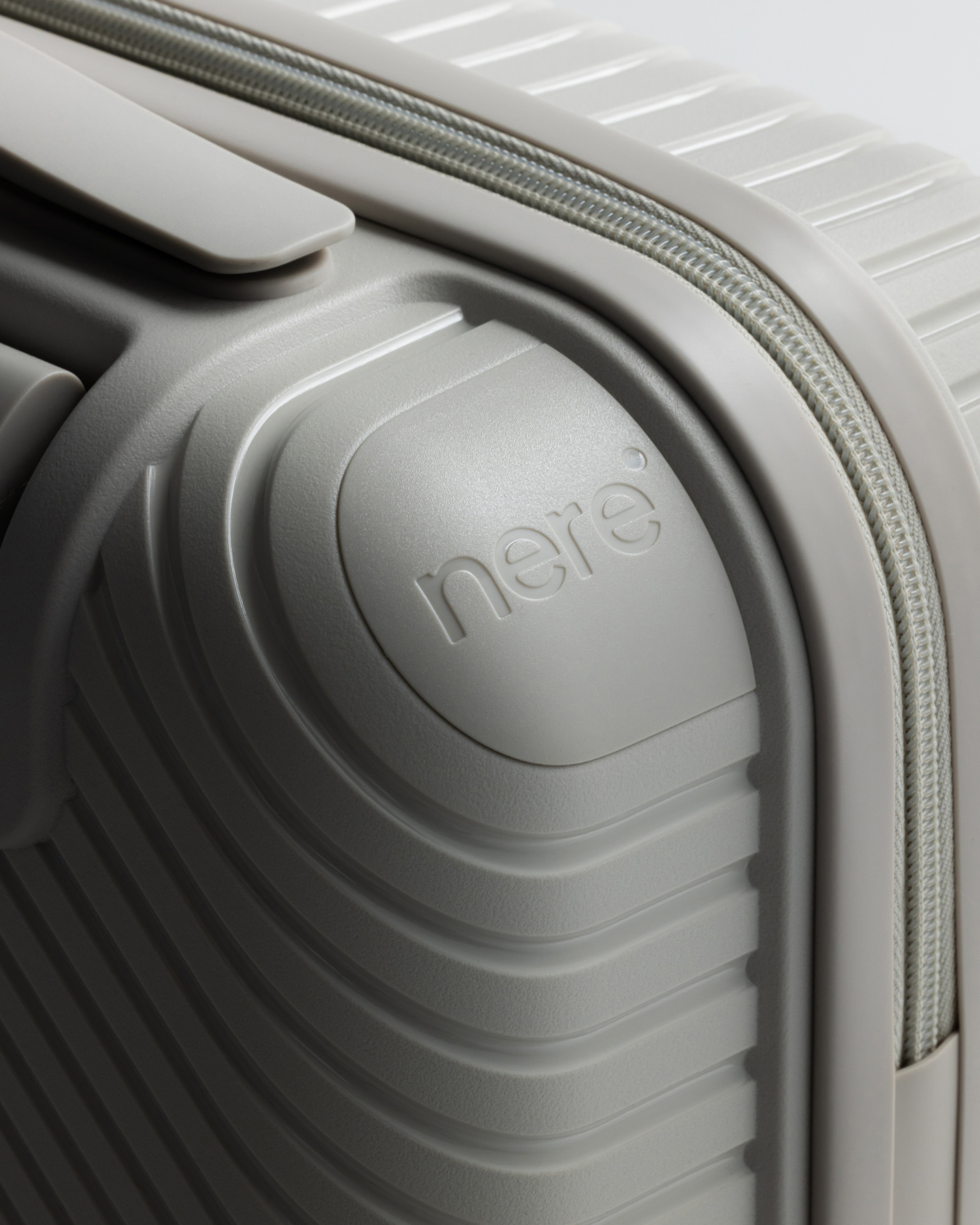 Close-up of diagonal ridged texture on a grey hardshell suitcase corner